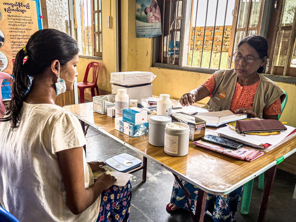 Two women are seated in a clinic. 